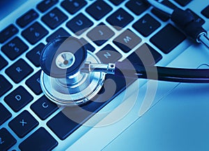 Close-up of stethoscope on laptop keyboard