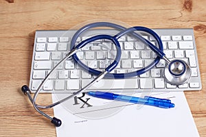 Close up of stethoscope on pc keyboard. Healthcare concept