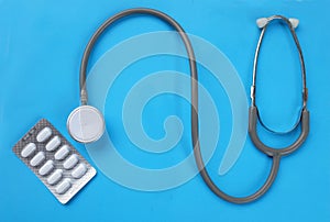 Close up Stethoscope and pill isolate on blue background  .Copy space Medical and health concept
