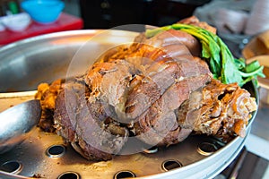 Close up stewed pork leg on stainless steel pot