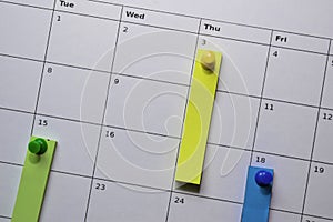 Close up stiky notes on a calendar. Schedule or plan concept