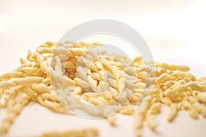 Close up still life of italian handmade pasta fusilli al ferretto on white background