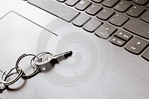 Close up of Still life of Key Ring on laptop computer keyboard. Conceptual image shown as network security key. Cyber Security,