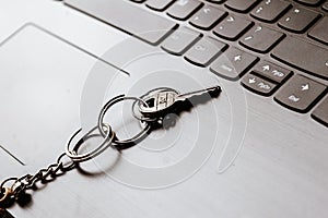 Close up of Still life of Key Ring on laptop computer keyboard. Conceptual image shown as network security key. Cyber Security,