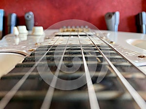 Close-up Stings and fret on electric guitar.