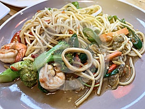 Close up of Stir fried noodles with shrimp and vegetables on the plate