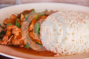 Close up stir fried pork with red curry paste and organic green bean , Thai food