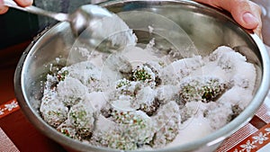 Close-up stirring white refined sugar white pine cones, preparing Siberian jam for the winter