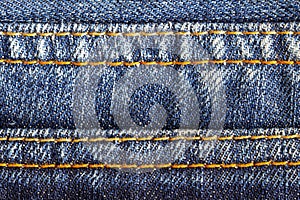 close-up of stitching detail on blue jeans