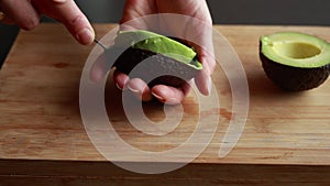 A close-up stock video showcasing a ripe avocado placed on a wooden cutting board