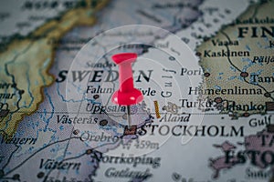 Close up of Stockholm pin pointed on the world map with a pink pushpin