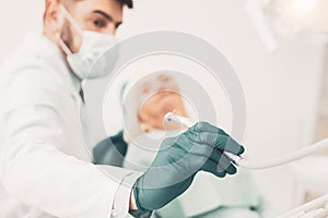 Close up of stomatologist taking dental drill