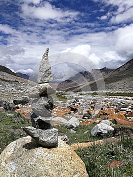 Close up stone balance with mountain landscape.