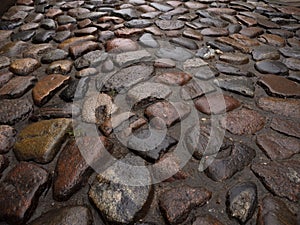 Close up of a stone cobblestone pavement wet after rain