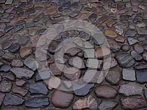Close up of a stone cobblestone pavement wet after rain