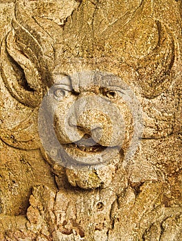 A close up of a stone Grotesque carved face