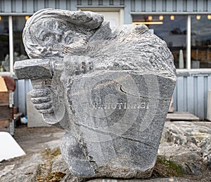 Close up of stone sculpture of man chiselling rock with hammer in Nuuk, Greenland