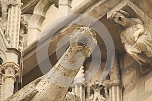 a close up of a stone sculpture near a building and angels