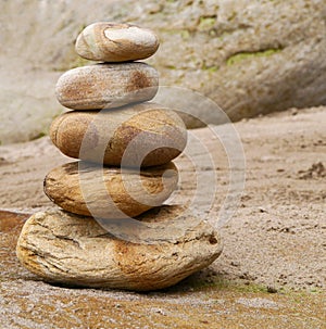 Close-up of stone stack on sandy beach