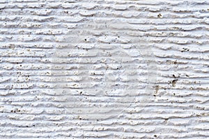 Close-up of stone surface with traces of processing. Parallel lines on the stone left by the cutting tool. Abstract