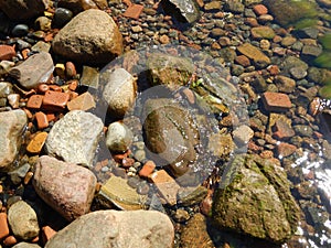 Close up of stones and bricks in the sea water. Seascape by the Ã–resund, Sweden