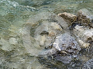 Close-up of stones in river washed by water