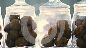 Close-up, stored in glass jars are seeds, walnuts, various species grown on breeding, hybrids of nuts. nuts of the best