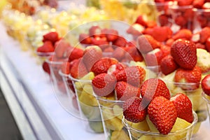 Close up Strawberries and pineapples arranged in clear plastic glasses Sold for Walking Street