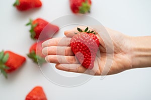 Close up of a strawberry in the palm of the hand