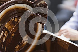 Close-up of stream of pouring hot chocolate. Concept of tasty sweet treats