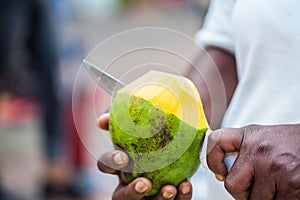 Close up of an street vendor man cutting a mango in the city of Cali in Colombia