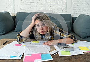 Close up of stressed and overwhelmed young woman paying bills and managing home finances