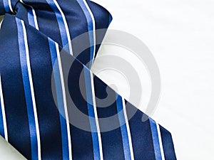 Close-up of striped blue and white tie isolated on white background.