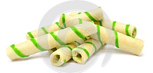 Close-up of striped wafer rolls on white