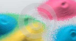 Close-up of stripes of rainbow colored sand in vivid primary colors in high resolution and sharpness