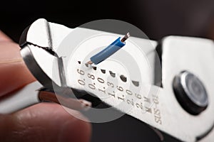Close-up of a stripped ground wire by a wire stripper