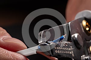 Close-up of a stripped ground wire by a wire stripper