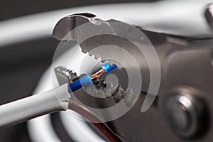 Close-up of a stripped ground wire by a wire stripper