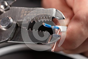 Close-up of a stripped ground wire by a wire stripper