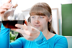 Close-up of a student performing an experiment in chemistry lab