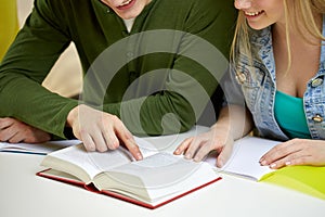 Close up of students reading book or textbook