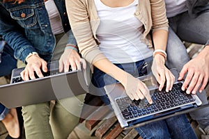 Close up of students or teenagers with laptop