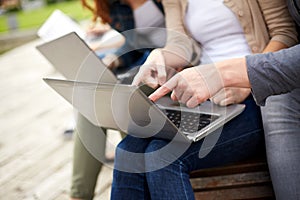 Close up of students or teenagers with laptop