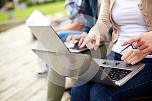 Close up of students or teenagers with laptop