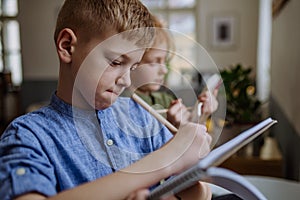 Close up of students writing notes in to their notepads.