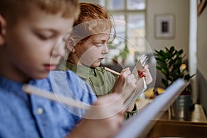 Close up of students writing notes in to their notepads.