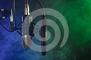 Close-up. Studio condenser microphone Radio, vocals, colored smoke podcasts. Copy space