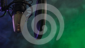 Close-up. Studio condenser microphone Radio, vocals, colored smoke podcasts. Copy space