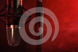 Close-up. Studio condenser microphone Radio, vocals, podcasts red smoke. Copy space photo