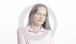 Close up studio shot of beautiful Caucasian young woman businesswoman looking at the camera with calm and serious expression